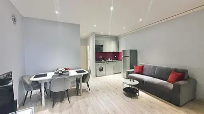 a living room with a couch and a table at Cannes 1-Bedroom Apartment - 15M in Cannes