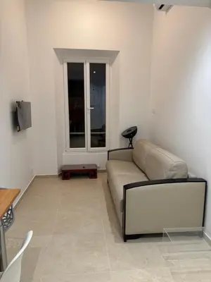 a living room with a couch and a window at STA4 Le Suquet, Proche Mer et Palais des Congrès in Cannes