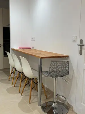 a wooden table with four white chairs around it at STA4 Le Suquet, Proche Mer et Palais des Congrès in Cannes