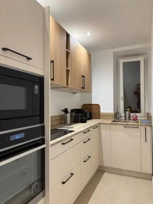 a kitchen with white cabinets and a microwave at STA4 Le Suquet, Proche Mer et Palais des Congrès in Cannes