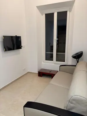 a living room with a white couch and a window at STA4 Le Suquet, Proche Mer et Palais des Congrès in Cannes