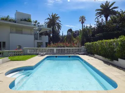 a swimming pool in the backyard of a house at Villa Divona - central gem with sunset balcony & pool in Cannes