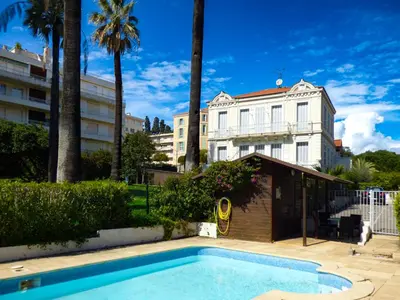 a swimming pool in front of a building at Villa Divona - central gem with sunset balcony & pool in Cannes