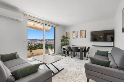 a living room with two couches and a table at REF 1996 Cannes Croisette - Sea view apartment for rent in Cannes