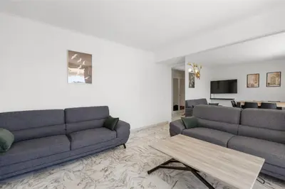 a living room with two couches and a table at REF 1996 Cannes Croisette - Sea view apartment for rent in Cannes