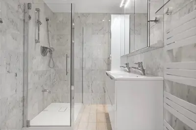 a white bathroom with a shower and a sink at REF 1996 Cannes Croisette - Sea view apartment for rent in Cannes