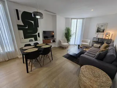 a living room with a couch and a table at 2 Bedrooms 5 min walk to Croisette in Cannes