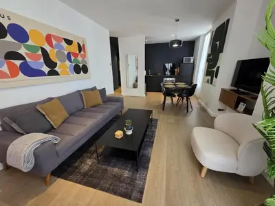 a living room with a couch and a table at 2 Bedrooms 5 min walk to Croisette in Cannes