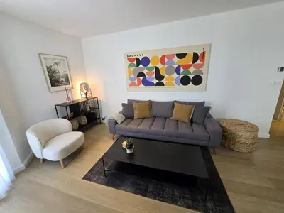 a living room with a couch and a chair at 2 Bedrooms 5 min walk to Croisette in Cannes