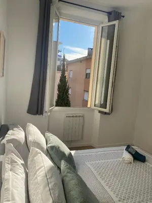 a living room with a couch and a window at Elégant T3 Cannes centre, 10 mn à pieds Palais, Croisette in Cannes