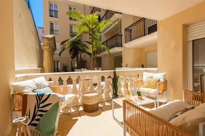 a living room with a couch and a table at Sunny Palazzio T3 Old Port, Beaches, Congress in Cannes