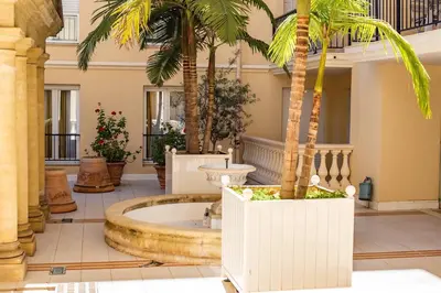 a lobby with palm trees and a large tub at Sunny Palazzio T3 Old Port, Beaches, Congress in Cannes