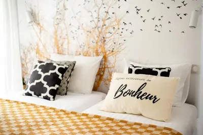a bedroom with a bed with black and white pillows at Sunny Palazzio T3 Old Port, Beaches, Congress in Cannes