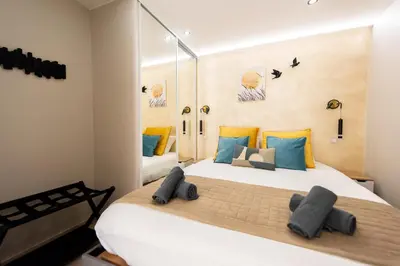a living room with a couch and a table and chairs at Sunny Palazzio T3 Old Port, Beaches, Congress in Cannes