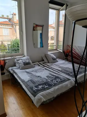 a bedroom with two teddy bears sitting on a bed at Center palais in Cannes