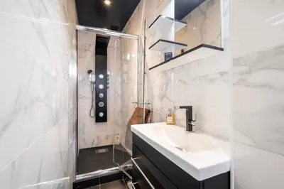 a bathroom with two sinks and a tub and a mirror at Center palais in Cannes