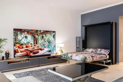 a living room with a couch and a flat screen tv at Center palais in Cannes