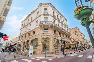 a building on the corner of a street at Center palais in Cannes