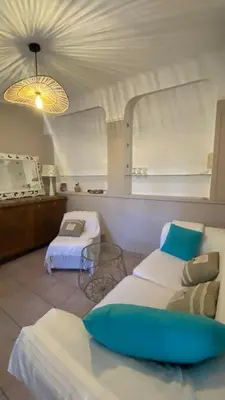 a room with two beds and a table in a room at une pépite ZEN et COSY, parking jardin, idéal pour se ressourcer au calme in Le Cannet