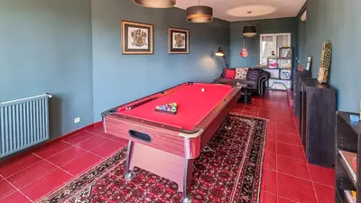 a red pool table in a room with a couch at Villa 4 BR with pool, 5 minutes Cannes in Le Cannet