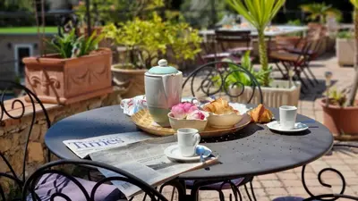 a table with a tea pot and food on it at Villa 4 BR with pool, 5 minutes Cannes in Le Cannet