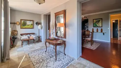 a living room with a table and a chair at Villa 4 BR with pool, 5 minutes Cannes in Le Cannet