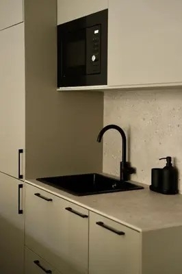 a kitchen with a sink and a microwave at Somptueux avec grande terrasse in Cannes