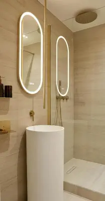 a bathroom with a white sink and two mirrors at Somptueux avec grande terrasse in Cannes