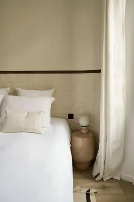 a bedroom with a white bed and a white curtain at Somptueux avec grande terrasse in Cannes