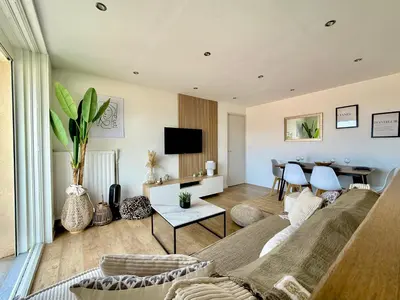 a living room with a couch and a table at T3 Sea view walking distance of Palais, AC , Parking, Terrace in Cannes