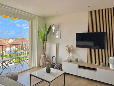 a living room with a flat screen tv on a wall at T3 Sea view walking distance of Palais, AC , Parking, Terrace in Cannes