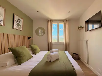 a bedroom with a bed with green pillows and a window at T3 Sea view walking distance of Palais, AC , Parking, Terrace in Cannes