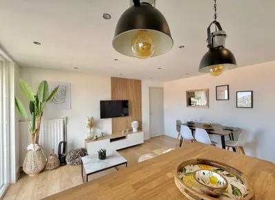 a living room with a table and a dining room at T3 Sea view walking distance of Palais, AC , Parking, Terrace in Cannes