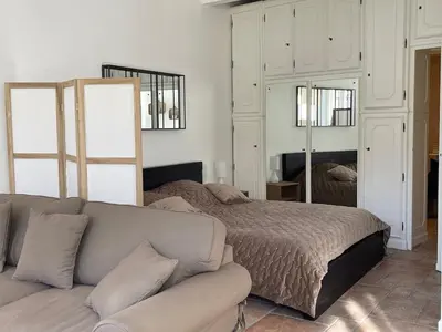 a living room with a bed and a couch at CANNES SUQUET spacieux studio in Cannes
