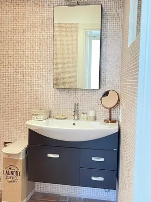 a bathroom with a sink and a mirror at CANNES SUQUET spacieux studio in Cannes