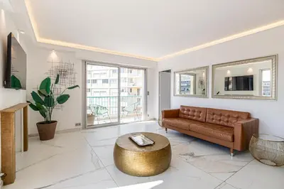 a living room with a couch and a table at Modern apartment - 3BR- 6P - Croisette Plage in Cannes