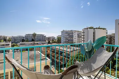 two chairs on a balcony with a view of a city at Modern apartment - 3BR- 6P - Croisette Plage in Cannes