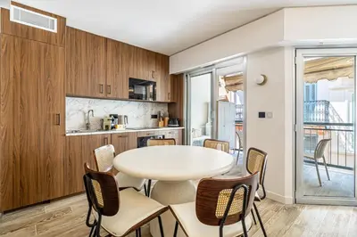 a kitchen and dining room with a table and chairs at Charming flat - 2BR-6P - Cannes in Cannes