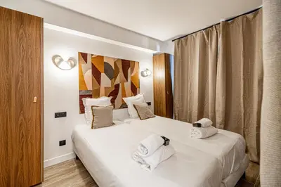 two beds in a hotel room with white towels at Charming flat - 2BR-6P - Cannes in Cannes