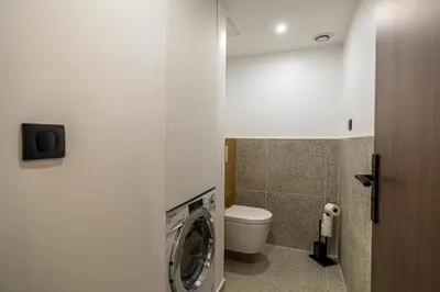 a bathroom with a washing machine and a toilet at Charming flat - 2BR-6P - Cannes in Cannes