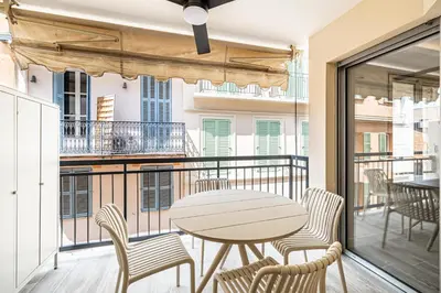 a patio with a table and chairs on a balcony at Charming flat - 2BR-6P - Cannes in Cannes