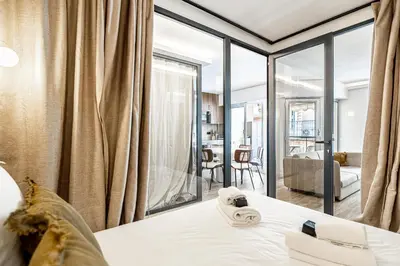 a bedroom with a bed and a large window at Charming flat - 2BR-6P - Cannes in Cannes