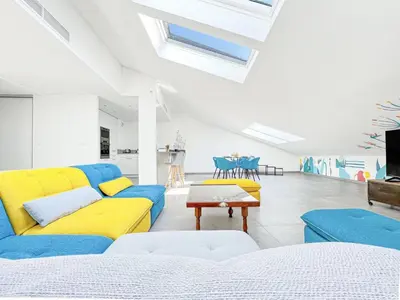 a living room with yellow and blue couches and a table at Sky Croisette - Palais des Festivals et des Congrès in Cannes