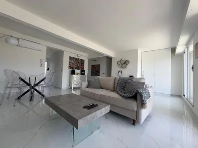 a living room with a couch and a coffee table at Cannes 2 suites 2 terrasses in Cannes