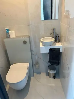 a white bathroom with a toilet and a sink at Cannes 2 suites 2 terrasses in Cannes