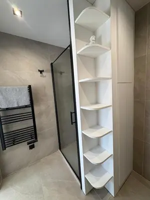 a bathroom with a walkin closet with white shelves at Cannes 2 suites 2 terrasses in Cannes