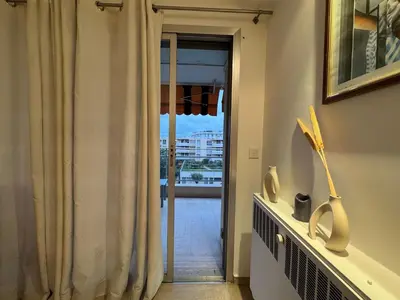 a room with a door with a view of a balcony at 90 m2 Palm Beach apartment with 2 balconies Very stylish and central in Cannes