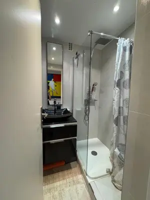 a bathroom with a sink and a shower at 90 m2 Palm Beach apartment with 2 balconies Very stylish and central in Cannes