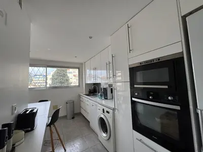 a kitchen with a washer and dryer in it at 90 m2 Palm Beach apartment with 2 balconies Very stylish and central in Cannes