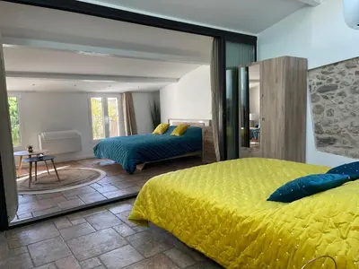 a bedroom with a yellow bed and a large mirror at CANNES SUQUET beautiful Duplex in Cannes